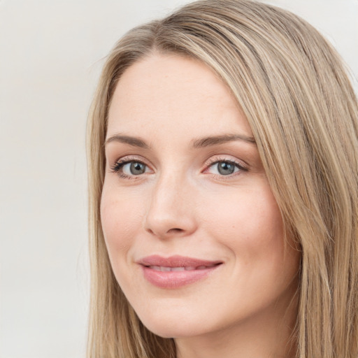 Joyful white young-adult female with long  brown hair and green eyes