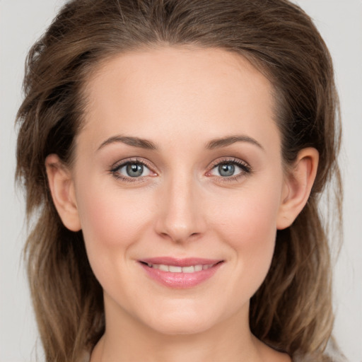 Joyful white young-adult female with long  brown hair and grey eyes