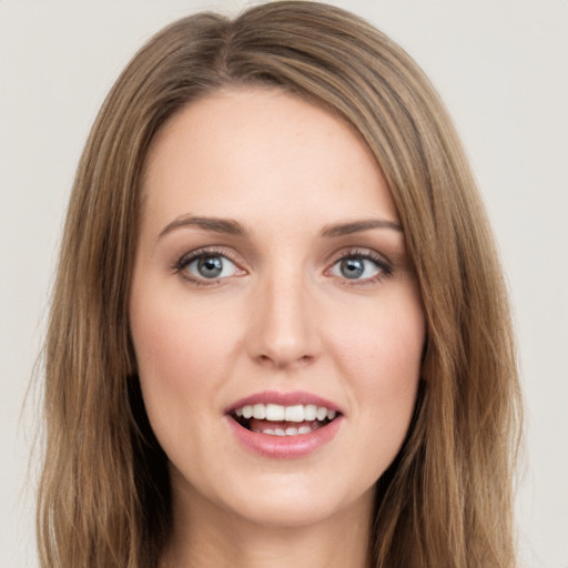 Joyful white young-adult female with long  brown hair and green eyes