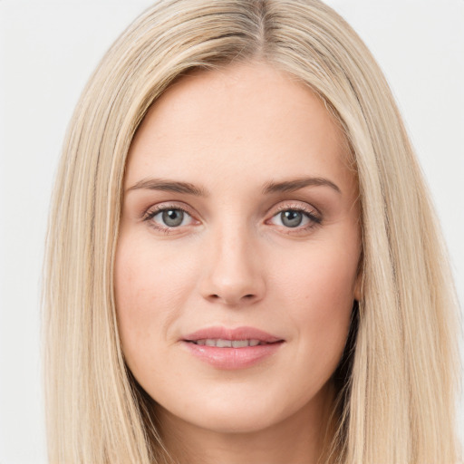 Joyful white young-adult female with long  brown hair and blue eyes