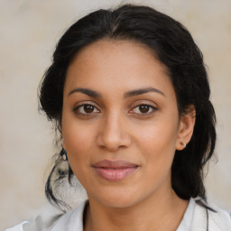 Joyful latino young-adult female with medium  brown hair and brown eyes