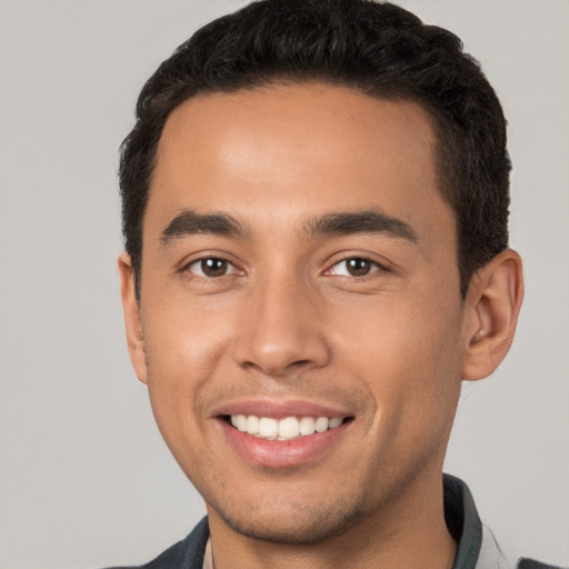 Joyful white young-adult male with short  black hair and brown eyes