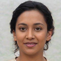 Joyful latino young-adult female with medium  brown hair and brown eyes