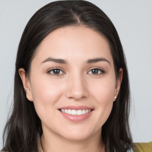 Joyful white young-adult female with long  brown hair and brown eyes