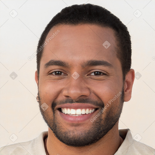 Joyful black young-adult male with short  brown hair and brown eyes