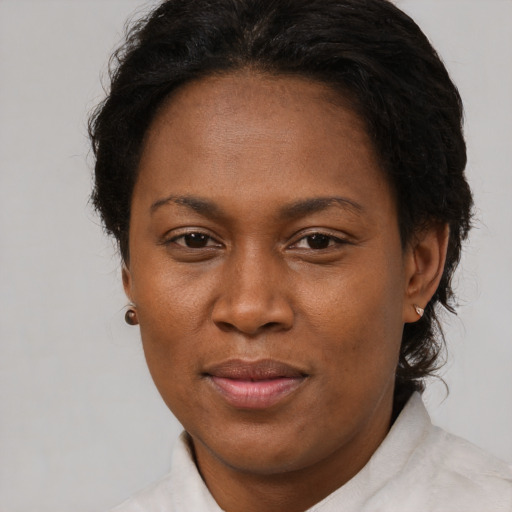 Joyful black adult female with short  brown hair and brown eyes