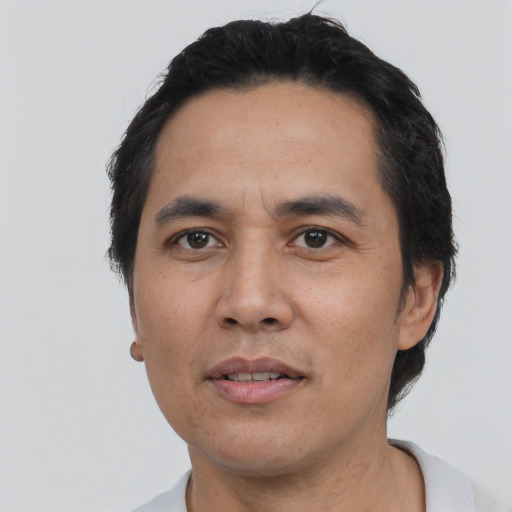 Joyful asian adult male with short  black hair and brown eyes