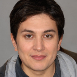 Joyful white young-adult male with medium  brown hair and brown eyes