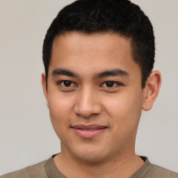 Joyful latino young-adult male with short  brown hair and brown eyes