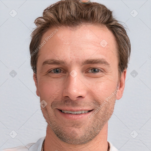 Joyful white adult male with short  brown hair and grey eyes