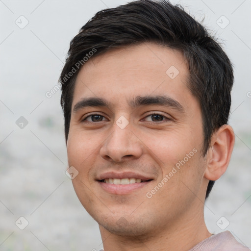 Joyful white young-adult male with short  black hair and brown eyes