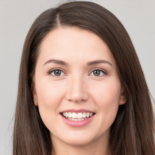 Joyful white young-adult female with long  brown hair and brown eyes