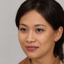 Joyful asian young-adult female with medium  brown hair and brown eyes