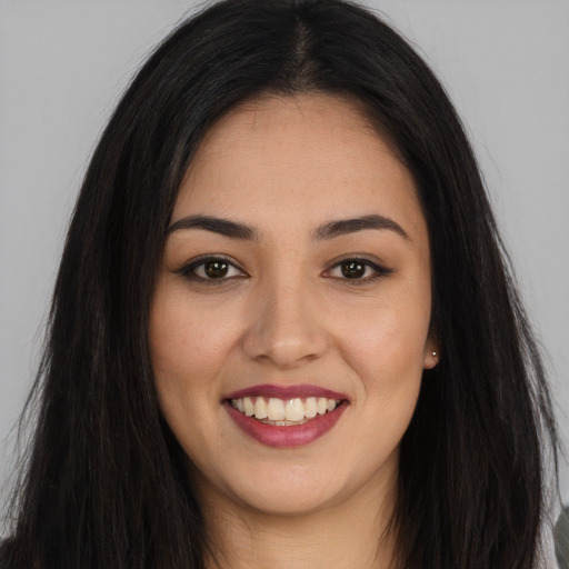 Joyful asian young-adult female with long  brown hair and brown eyes