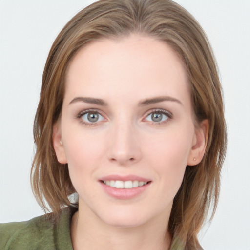 Joyful white young-adult female with long  brown hair and blue eyes