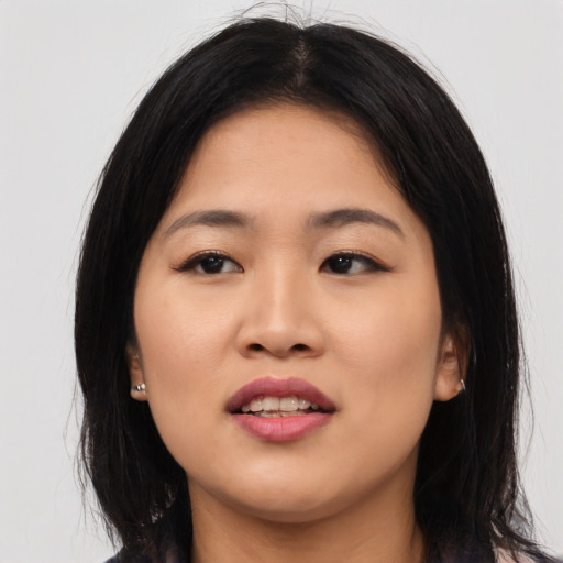 Joyful asian young-adult female with long  black hair and brown eyes