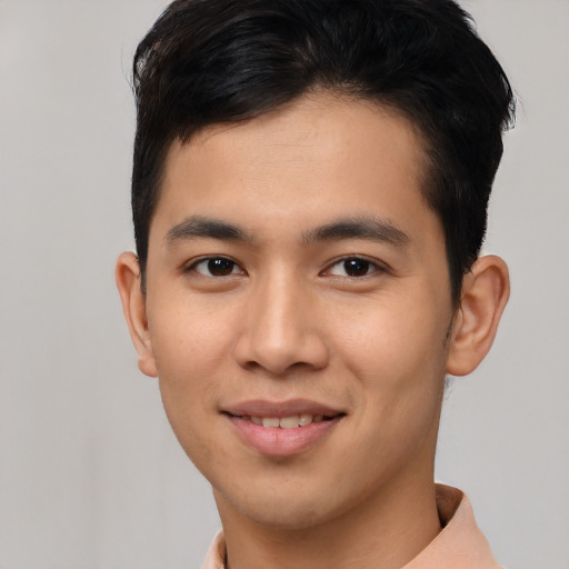 Joyful asian young-adult male with short  black hair and brown eyes