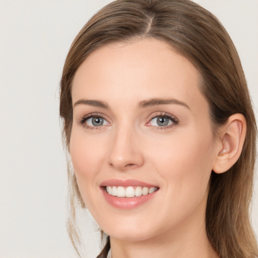 Joyful white young-adult female with long  brown hair and grey eyes