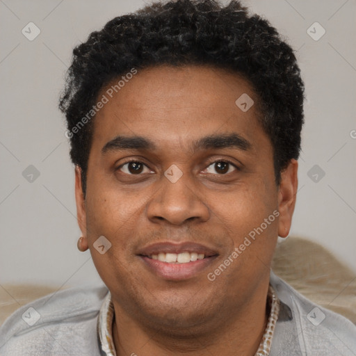 Joyful black young-adult male with short  brown hair and brown eyes