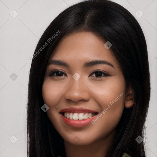 Joyful latino young-adult female with long  black hair and brown eyes