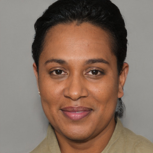 Joyful black adult female with short  black hair and brown eyes