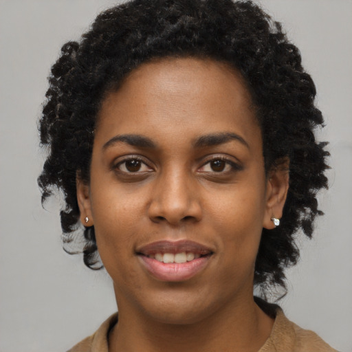 Joyful black young-adult female with medium  black hair and brown eyes
