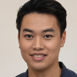 Joyful asian young-adult male with short  black hair and brown eyes