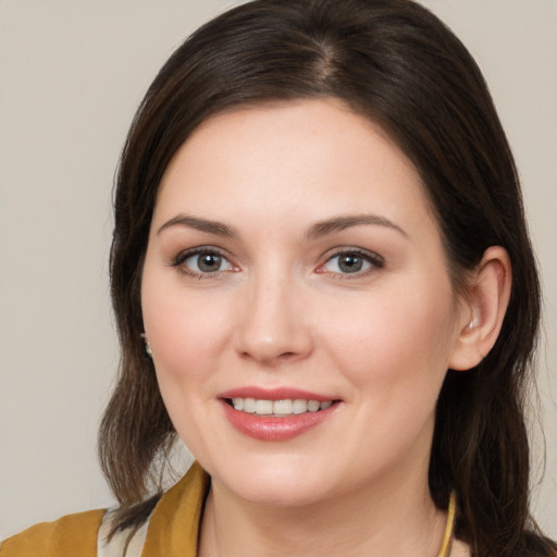 Joyful white young-adult female with medium  brown hair and brown eyes