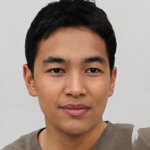 Joyful asian young-adult male with short  black hair and brown eyes