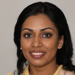 Joyful latino young-adult female with medium  black hair and brown eyes