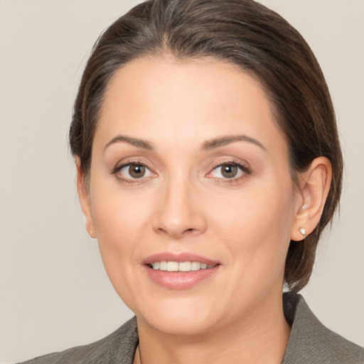 Joyful white adult female with medium  brown hair and brown eyes