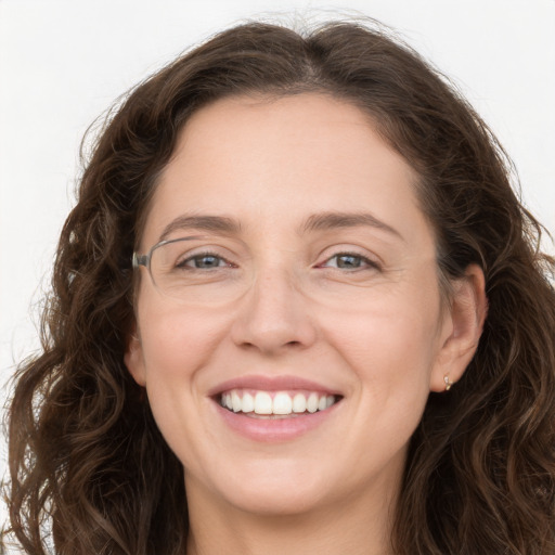 Joyful white young-adult female with long  brown hair and green eyes