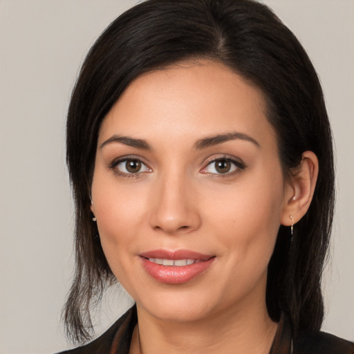 Joyful white young-adult female with medium  black hair and brown eyes