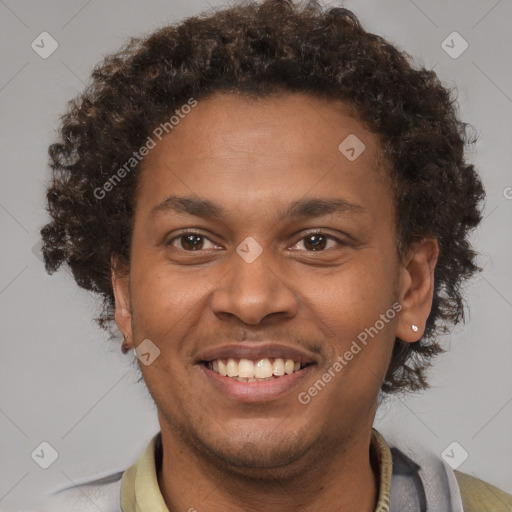 Joyful black young-adult male with short  brown hair and brown eyes