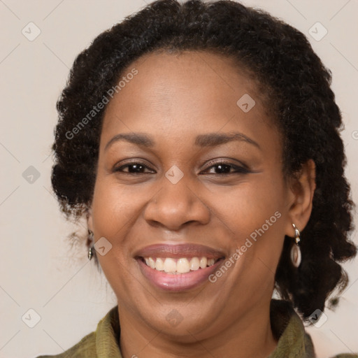 Joyful black adult female with medium  brown hair and brown eyes