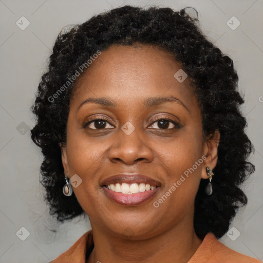 Joyful black young-adult female with long  brown hair and brown eyes