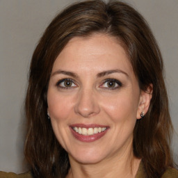 Joyful white adult female with medium  brown hair and brown eyes