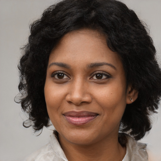 Joyful black young-adult female with medium  black hair and brown eyes