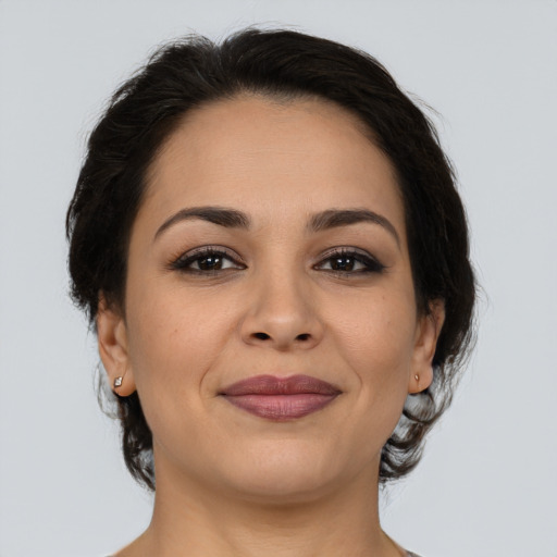 Joyful latino young-adult female with medium  brown hair and brown eyes