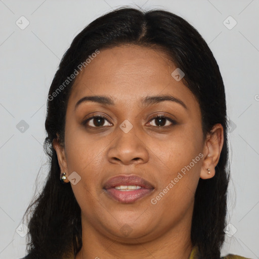 Joyful black adult female with long  brown hair and brown eyes