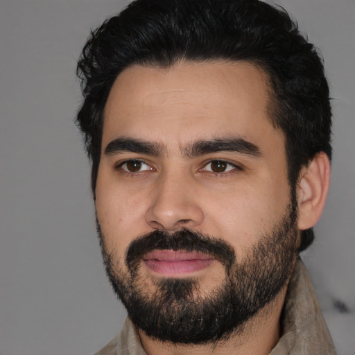 Joyful latino young-adult male with short  black hair and brown eyes
