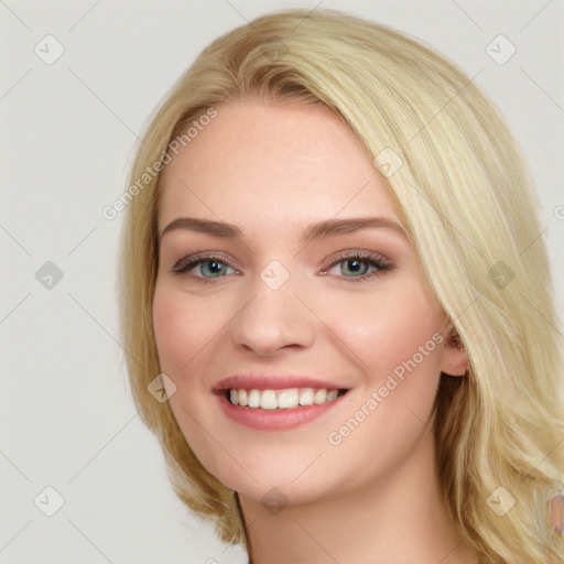 Joyful white young-adult female with long  brown hair and blue eyes