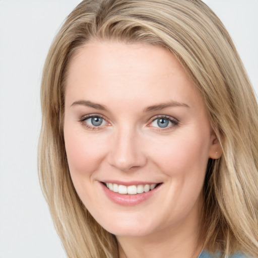 Joyful white young-adult female with long  brown hair and blue eyes