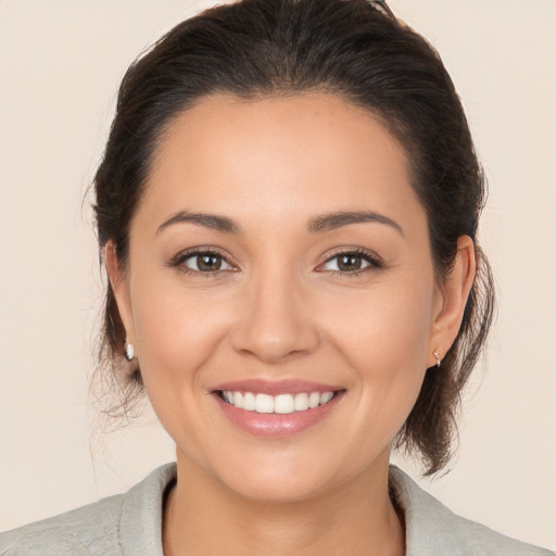 Joyful white young-adult female with medium  brown hair and brown eyes