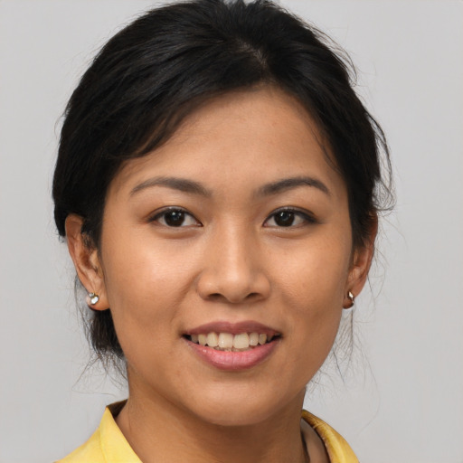 Joyful asian young-adult female with medium  brown hair and brown eyes