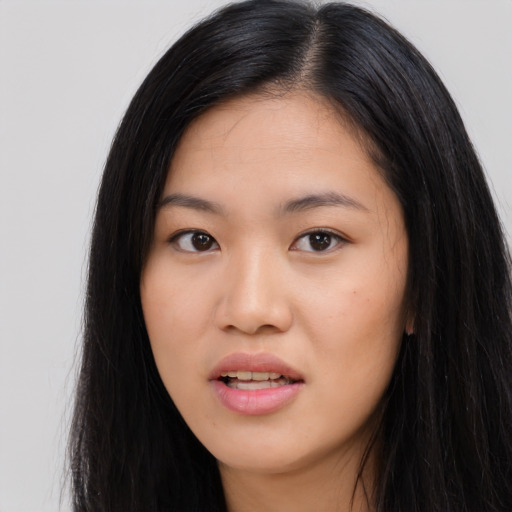 Joyful asian young-adult female with long  black hair and brown eyes