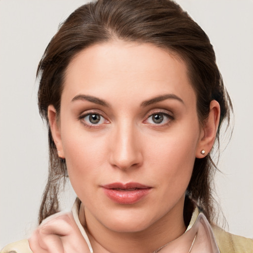 Joyful white young-adult female with medium  brown hair and grey eyes