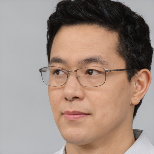 Neutral asian adult male with short  black hair and brown eyes