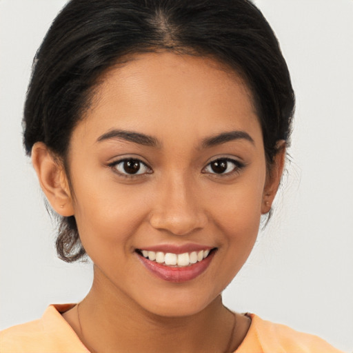 Joyful latino young-adult female with medium  brown hair and brown eyes