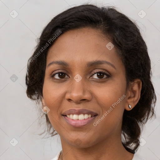 Joyful black adult female with medium  brown hair and brown eyes